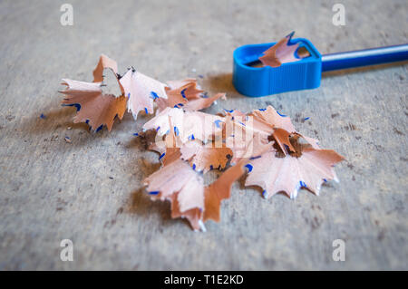 Close up of a pencil sharpened with a sharpener with pencil peels and black graphite lead waste Stock Photo