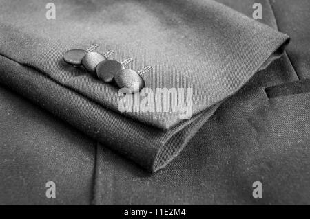 Buttons on the sleeves of a grey blazer suit Stock Photo