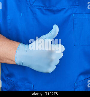 doctor in blue uniform shows a gesture of approval, like, close up Stock Photo
