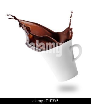 Hot chocolate splashes out of tilted white cup Stock Photo