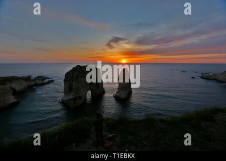 Beirut, Lebanon. 25th Mar, 2019. Sunset is seen at Raouche Rocks in Beirut, Lebanon, on March 25, 2019. Credit: Bilal Jawich/Xinhua/Alamy Live News Stock Photo