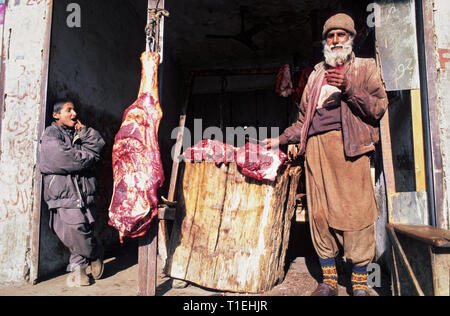 March 19, 2012 - Gilgit, Hunza District, Pakistan - FILE IMAGE taken on January 2000 - A butcher from Gilgit (Hunza Valley, Pakistan) stands at his shop displaying animal meats. (Credit Image: © Jordi Boixareu/ZUMA Wire) Stock Photo