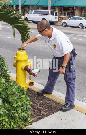 Miami Beach Florida,Hispanic man men male,city worker,workers,working,work,employee worker workers staff,fire inspector,hydrant,testing,water pressure Stock Photo