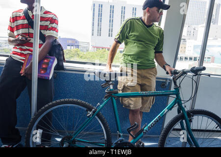 Miami Florida,Metromover,APM,automated people mover,public transportation,mass transit,station,adult adults man men male,bicycle,bicycling,riding,biki Stock Photo