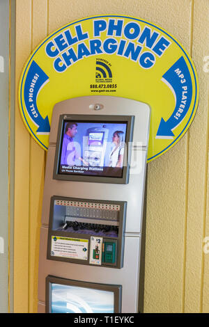 Miami Beach Florida,Miami Beach Convention Center,mobile device,charging station,rapid charge,smartphone cell phone phones,checking looking reading te Stock Photo