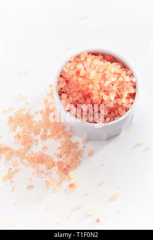 Big Crystals of pink Himalayan salt in jar. White background. Top view. Stock Photo
