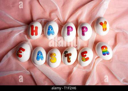 Happy Easter note written on eggs flat lay Stock Photo