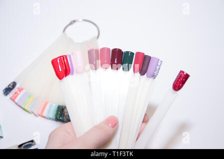 Nail Care And Manicure concept. Multicolor Nail Polish palette for Client's Nails choise. Woman In Beauty Salon. Copyspace for text . variety of choic Stock Photo