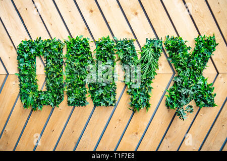 Onyx name logo planted in three-dimensional sign made with greenery plants at a building development Stock Photo