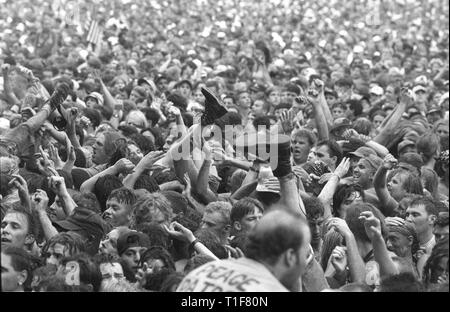 Boots, legs, arms and hands are all shown in motion out in the concert crowd at Woodstock 94. Stock Photo