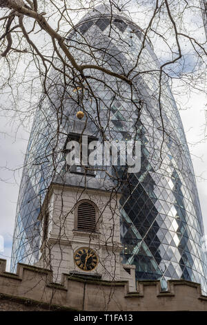 The 'Gherkin' looms over the church tower of St Helen's, Bishopsgate. Stock Photo