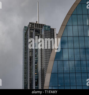 The steel mast of the Heron Tower glints in the sunshine above the facade of the 'Can of Ham' building at 70 St Mary Axe. Stock Photo