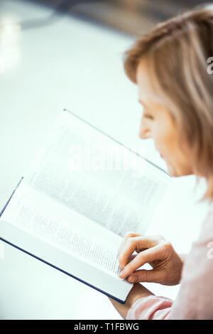 Close Up of a Reading Elderly Woman of European Appearance. Stock Photo