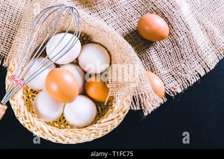Eggs on tablecloth over black background Stock Photo