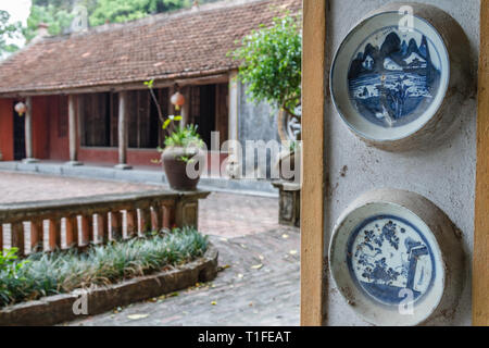 Vietnamese buildings at Ninh Binh, Northern Vietnam, decorated with white and blue ceramic plates.