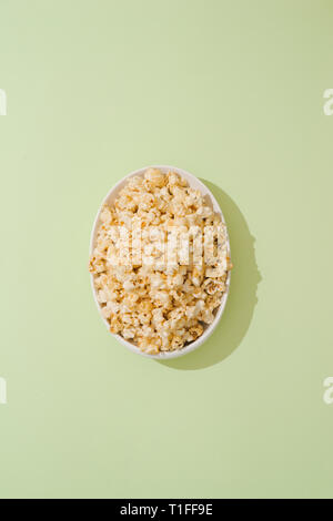 popcorn with caramel in a white porcelain bowl Stock Photo