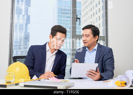 Coworkers working in office. Business people planning over desk Stock Photo