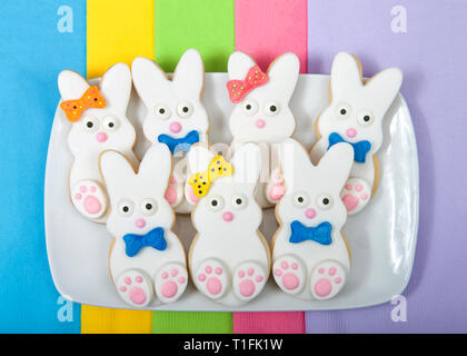 Easter Bunny Sugar Cookies on a rectangular plate with napkins underneath. Marshmallow fondant covered cookie with candy feet, eyes and nose and tail  Stock Photo