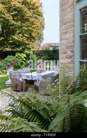 Garden dining table set for a dinner party Stock Photo