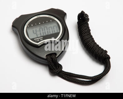 digital stop watch showing exactly 4 minutes.  Black plastic case with an LCD display.  Attached is a cord rolled into a tidy knot. Stock Photo
