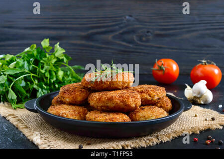 Juicy homemade cutlets (beef, pork, chicken) on a black background. Stock Photo