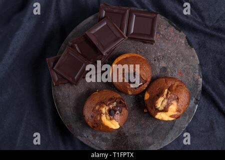Homemade gluten free muffins with chunks of bitter chocolate. Top down view Stock Photo