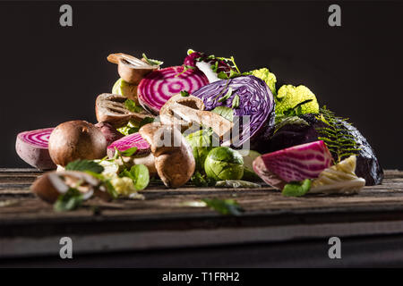 A pile of mushroom vegetables, beetroot and Brussels sprouts in studio light. Stock Photo