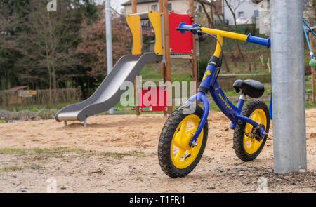 Kids bike parked on playground. Stock Photo