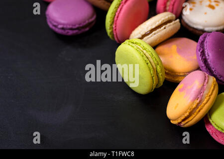 Assorted colorful macaroons on a dark background Stock Photo