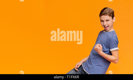 Excited boy cletching fist, making Yes gesture Stock Photo