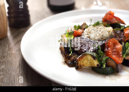 Beef steak with herb butter and grilled vegetables Stock Photo