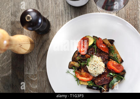 Exquisite, elegant dinner. Beef steak with herb butter and grilled vegetables Stock Photo