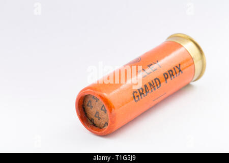 A paper case Eley Grand Prix 12 gauge, or bore, shotgun cartridge with a rolled turnover closure and loaded with No 4 lead shot pellets. Collecting sh Stock Photo