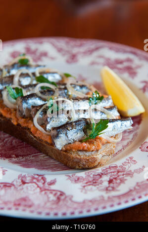 'Anchovies on bread in cocktail lounge of The Zetter Townhouse in London, England'
