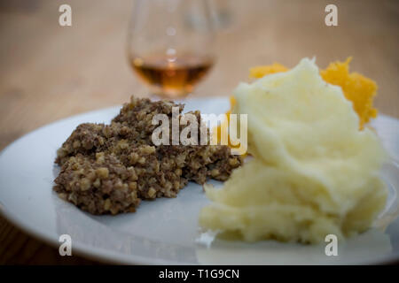 Freshly-cooked haggis made by Braveheart Butchers in Wallasey, Wirral, owned by champion haggis maker John Potter, who relocated from his native Scotland to Merseyside and continues to make award-winning haggis. Haggis is a dish containing sheep's 'pluck' (heart, liver and lungs), minced with onion, oatmeal, suet, spices, and salt, mixed with stock, and traditionally boiled in the animal's stomach for approximately three hours. It is a traditional Scottish dish usually served with 'neeps and tatties' (swede, yellow turnip and potatoes, boiled and mashed separately) and a 'dram' of Scotch whisk Stock Photo