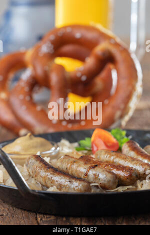 grilled nuremberger bratwurst with sauerkraut Stock Photo