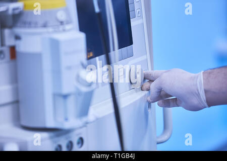 An anesthesia monitor shows real time vital signs for constant patient surveillance during surgery in a hospital, including heart rate, rhythm Stock Photo
