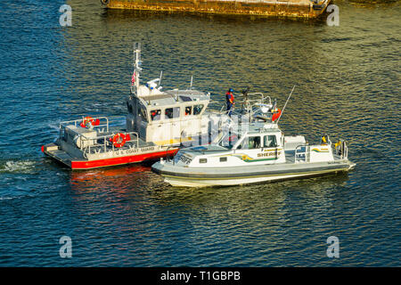 Sheriff boat meets with the US Coast Guard ship in Tampa Florida downtown waters on the Hillsbourough River for law enforcement exercise Stock Photo