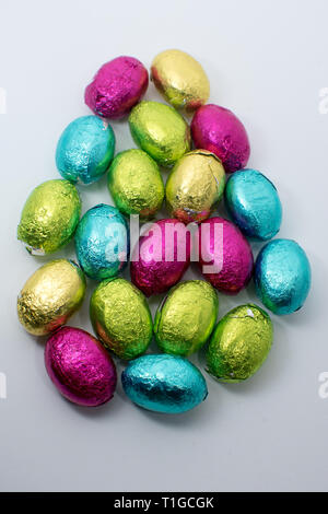 Easter egg chocolates wrapped in colorful silver foil arranged in egg shape Stock Photo
