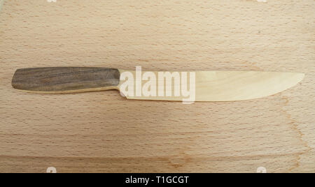 Wooden knife on wooden floor Stock Photo
