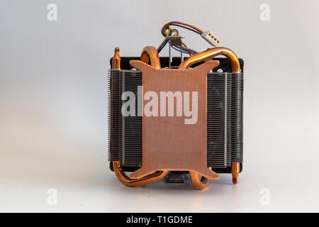 CPU heat sinker from a PC. Copper heatsinker with a fan for cooling the processor Stock Photo