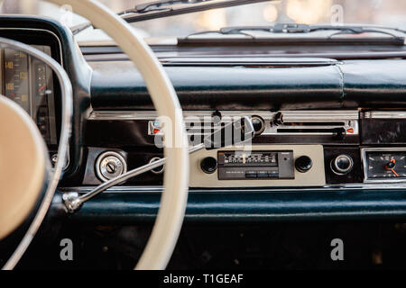 Retro styled image of an old car radio and dashboard inside a classic car Stock Photo