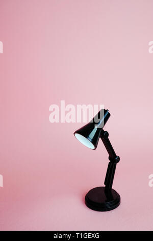 Black desk lamp isolated on pink background Stock Photo