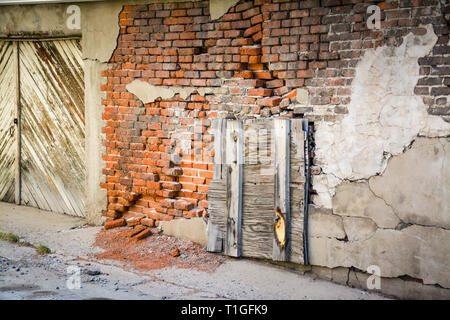 An old abandoned, weathered, rustic and crumbling commercial brick building in an old mining town in Western Montana, USA Stock Photo