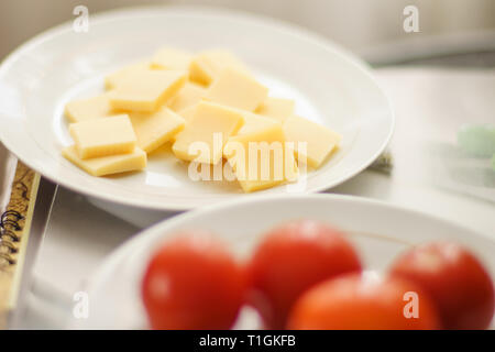 Cheese sliced in a plate. Stock Photo