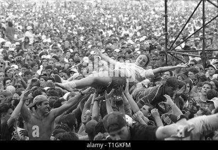 A concert fan is shown crowd surfing during Woodstock 94' in Saugerties, New York. Stock Photo
