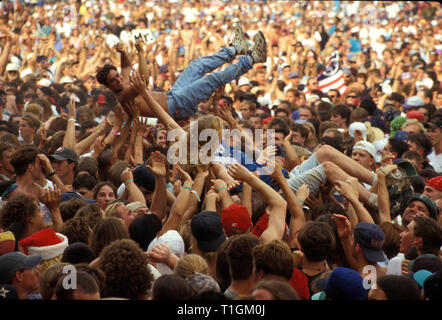 Concert fans are shown being passed around the crowd during Woodstock 94 in Saugerties, New York. Stock Photo