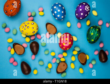 Easter background. Easter eggs multicolored and chocolate on a blue background. Texture and background. Stock Photo