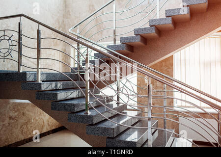 Staircase in modern buisness center building. Emergency evacuation exit. Stairs in shopping mall. White ladder by window in hotel. Urban architecture. Stock Photo