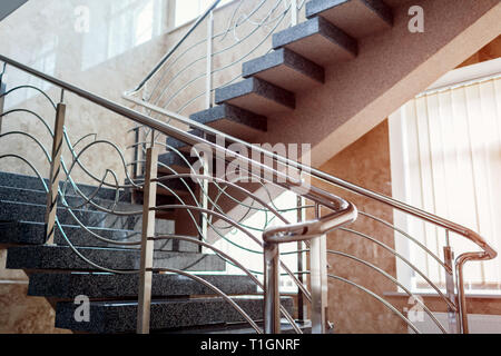 Staircase in modern buisness center building. Emergency evacuation exit. Stairs in shopping mall. White ladder by window in hotel. Urban architecture. Stock Photo